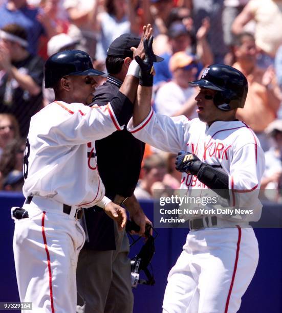 New York Mets' Desi Relaford celebrates with Rey Ordonez after they scored on a Joe McEwing double in the second inning.The Mets went on to beat the...