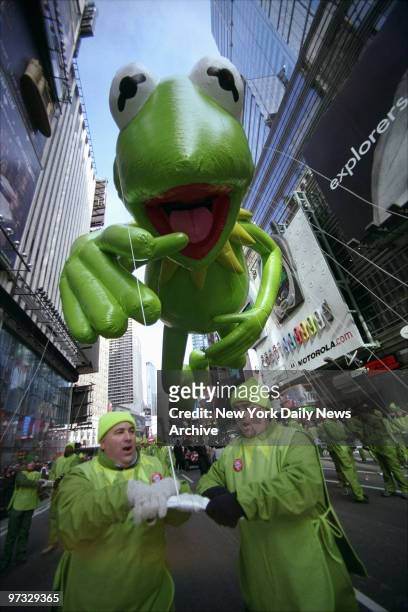 Kermit the Frog, the official mascot of the 76th annual Macy's Thanksgiving Day Parade, is a handful for the legion of workers towing the...