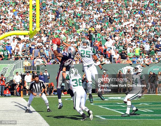 Kerry Rhodes does part to break up pass to New England Patriots wide receiver Randy Moss in end zone in waning seconds of first half as Jets safety...