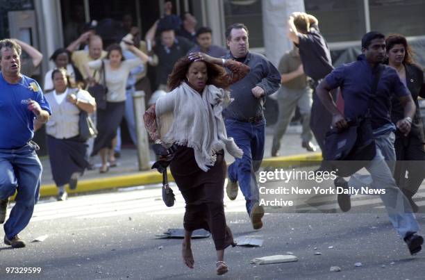 World Trade Center Terrorist Attack-People scramble for cover under a shower of debris after the World Trade Center is struck in a terrorist attack....