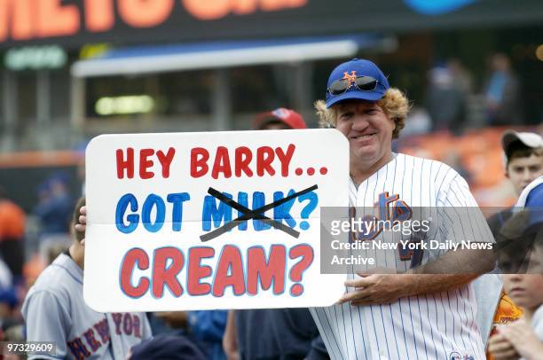 New York Mets' fan heckles San Francisco Giants' Barry Bonds with a sarcastic sign referring to Bonds' allegedly accidental use of a steroid cream...