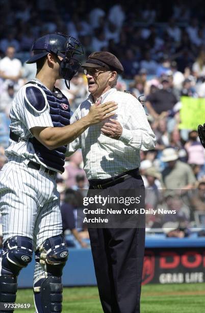 Detroit Tigers' announcer Ernie Harwell has a few words with New York Yankees' Jorge Posada after throwing out the ceremonial first pitch before the...