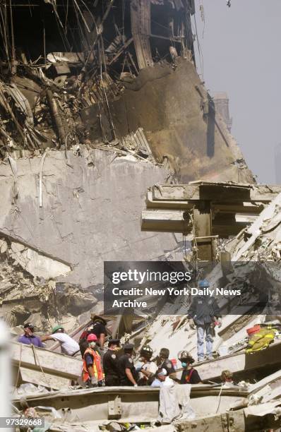 World Trade Center Terrorist Attack-Rescue crew works amid tons of mangled debris at site of the demolished World Trade Center as the search for...