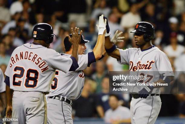 Detroit Tigers' Craig Monroe is congratulated by teammates after he hit a three-run homer in the ninth inning to defeat the New York Yankees, 5-3, in...