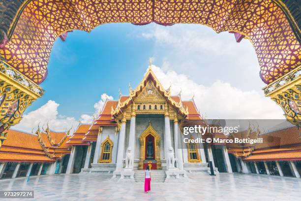 solo traveller woman walking inside the wat benchamabophit temple, bangkok - temple stock pictures, royalty-free photos & images