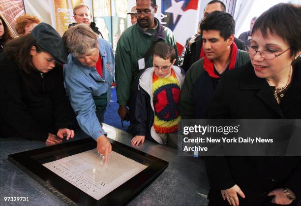 Visitors read an original signed copy of the Declaration Independence on display at a new exhibit called Democracy Plaza at Rockefeller Center. The...