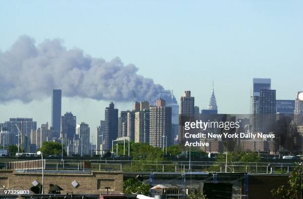 World Trade Center Terrorist Attack-Smoke billows over lower Manhattan after 1 World Trade Center collapses - the aftermath of a terrorist attack. A...
