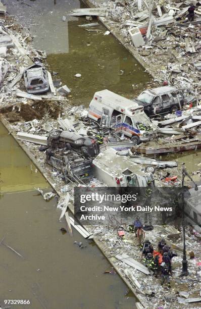 World Trade Center Terrorist Attack-The center median of the West Side Highway is strewn with debris and wrecked emergency vehicles beneath the area...