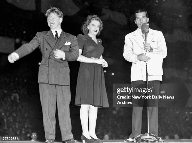 Mickey Rooney and Judy Garland with Ed Sullivan at the Harvest Moon Ball in Madison Square Garden.