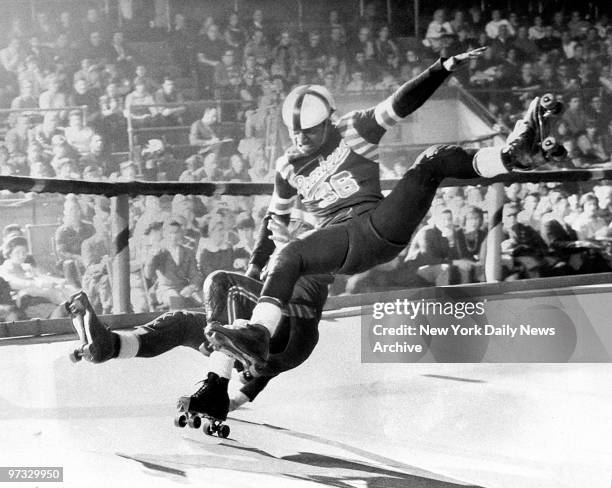 Dewitt Charles , of the San Francisco Bay Bombers, takes out Buzz Sanders of the New York Chiefs during roller derby match.