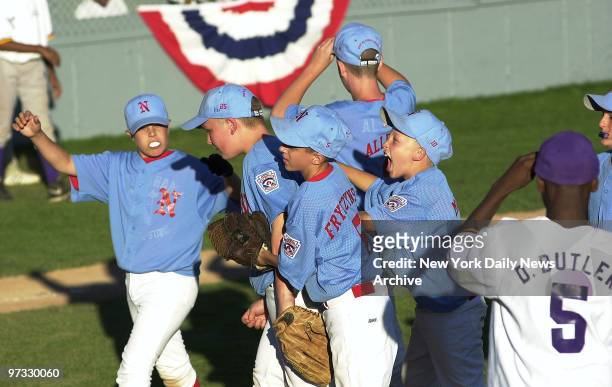 Nottingham Little League players from Hamilton, N.J., celebrate their 5-2 victory over Harlem in the regional playoffs in Bristol, Conn. But the New...