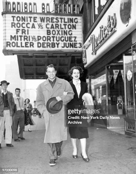 Middleweight boxing champ of Europe, Tiberio Mitri, and wife Fulvia, former Miss Italy of 1948, walk under the Madison Square Garden marquee on...