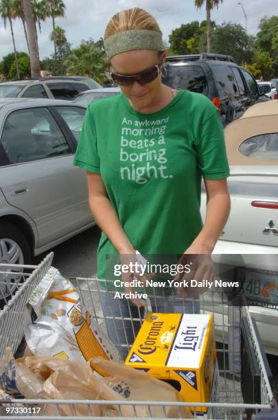 Simpson's girlfriend Christie Prody begins to load her car with groceries after shopping at Publix in the Krendal Mall on Saturday morning.