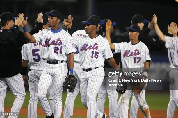 New York Mets' Gerald Williams , Richard Hidalgo and Wilson Delgado slap hands with teammates after defeating the Atlanta Braves, 9-4, at Shea...