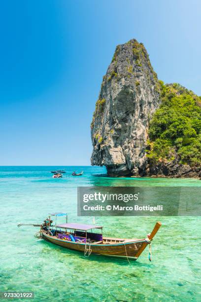 longtail boat moored in idyllic beach, thailand - krabi stock pictures, royalty-free photos & images