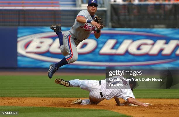 New York Mets' infielder Joe McEwing is out at second as Montreal Expos' Jose Vidro throws to first for a double play after a grounder by Mets' Mike...