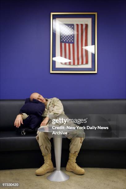Kevin Wilson of Peoria, Ill., catches some shuteye in the USO office at Hartsfield-Jackson Atlanta International Airport. Three hundred soldiers...