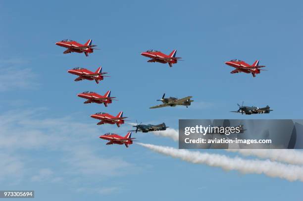 Red Arrows Royal Airforce BAE Hawk T-1s flying in formation with three Spitfires and a Hurricane in the flying-display at RIAT 2007.