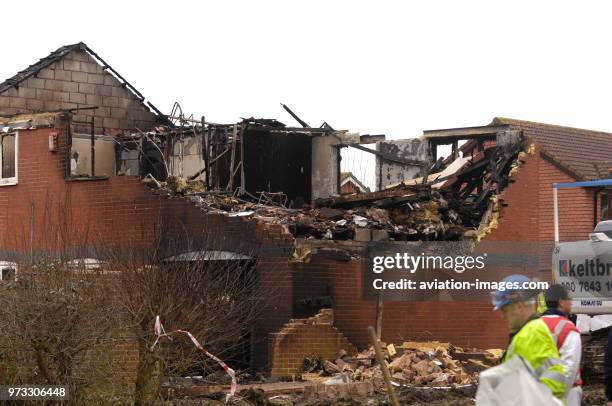 Keltbray digger and damaged house that had to be demolished at the scene of accident of Cessna 501 Citation VR-BGE that fatally crashed into the...