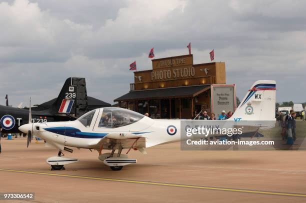 Royal Air Force RAF Grob G-115E Tutor T-1 and tail-fin of Short Tucano T-1 parked in the static-display at the 2009 Royal International Air Tattoo...