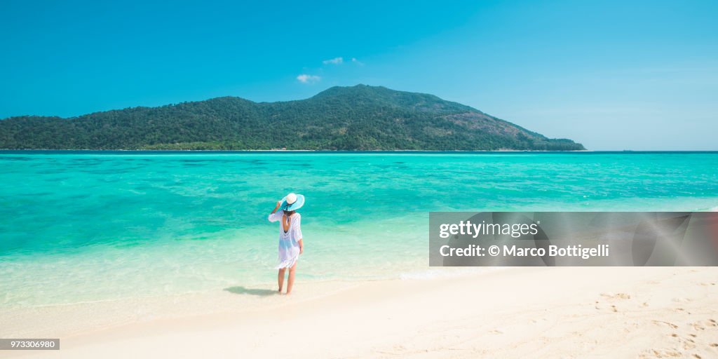 Woman standing on tropical beachin, Thailand