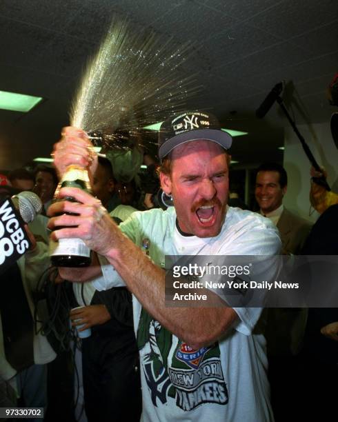 Yankees clinch Playoff by beating Brewers. Wade Boggs shakes and blasts bottle of champagne in clubhouse to celebrate.,