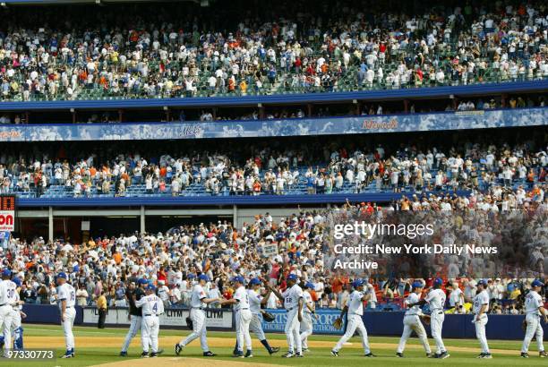With happy hometown fans packing the Shea Stadium stands, the New York Mets celebrate their 6-5 victory over the New York Yankees and their sweep of...