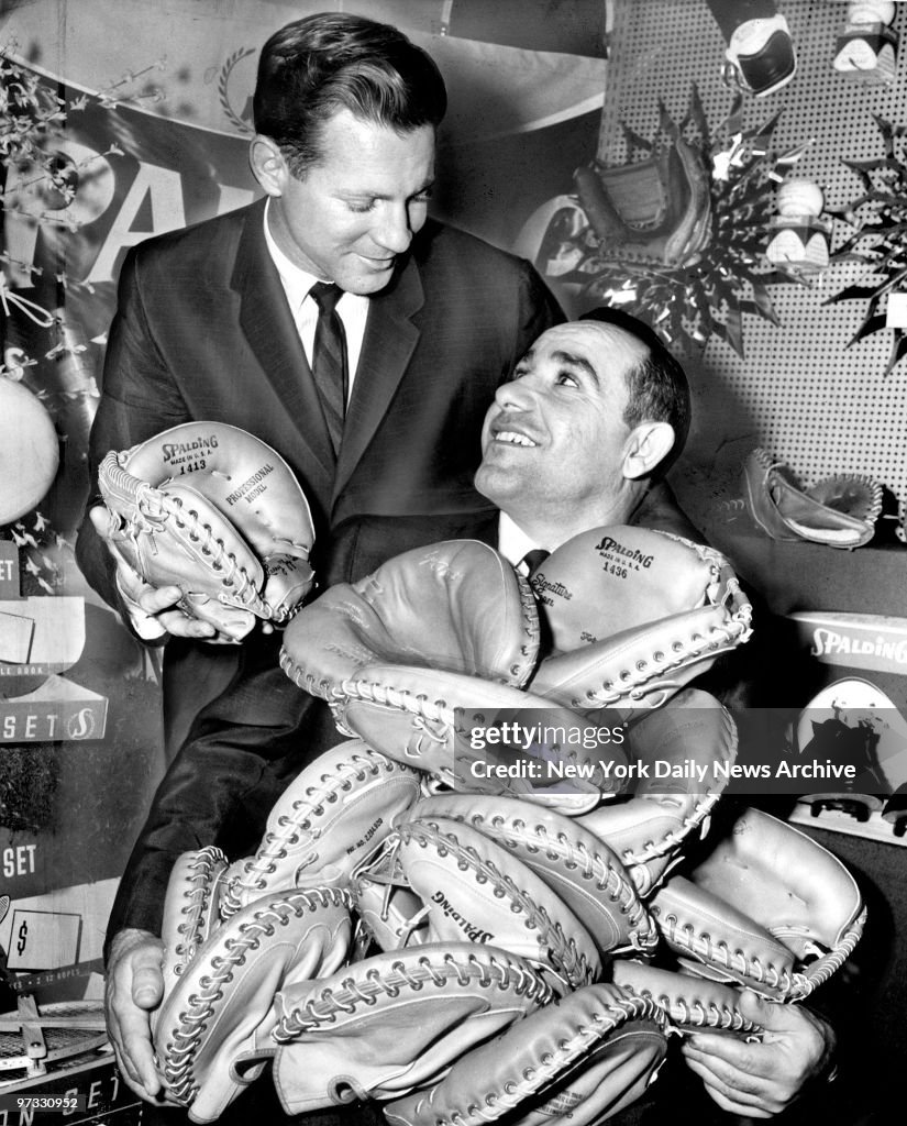 Yankee Yogi Berra is up to his ears in catchers mitts, thank