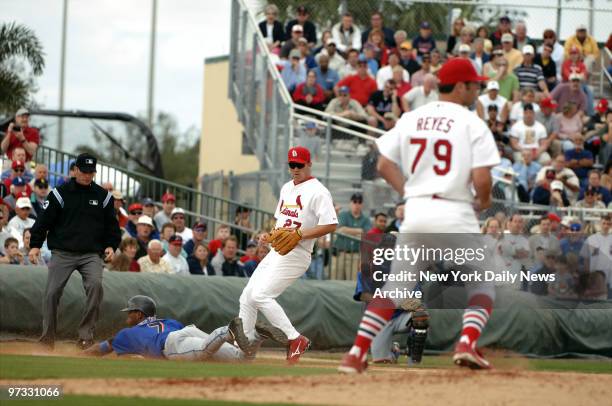 New York Mets' Jose Reyes dives onto third base while teammate Kaz Matsui is safe at second in a double steal, leaving St. Louis Cardinals' Scott...