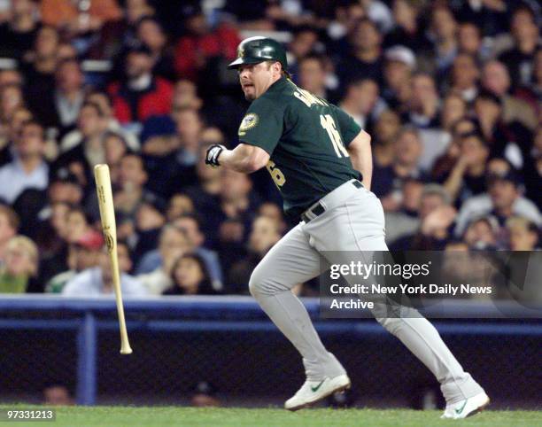 Oakland Athletics' Jason Giambi hits a long ball to the New York Yankees' Chuck Knoblauch, who missed it for an error in the third inning of Game 1...