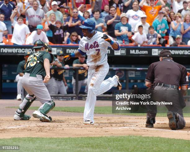 New York Mets' Jose Reyes leads off the bottom of the first inning with a double to right that resulted in his scoring on a two-base error by Oakland...