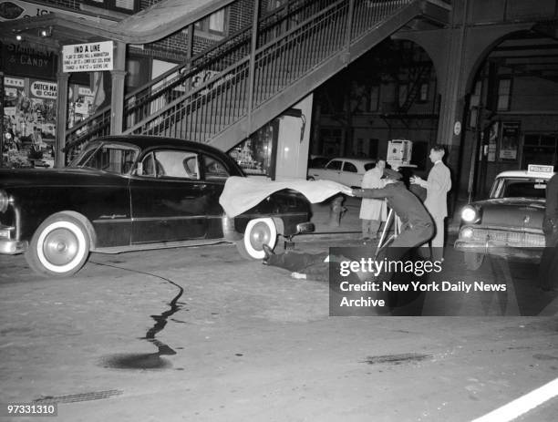 The body of Detective William F. Christman, 38-year-old father of five, is covered as it lies in street outside bar at 104-06 Liberty Ave., Ozone...