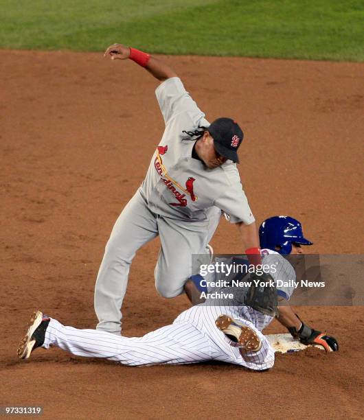 New York Mets' Jose Reyes steals second as St. Louis Cardinals' second baseman Ronnie Belliard falls onto him while applying the tag in the third...