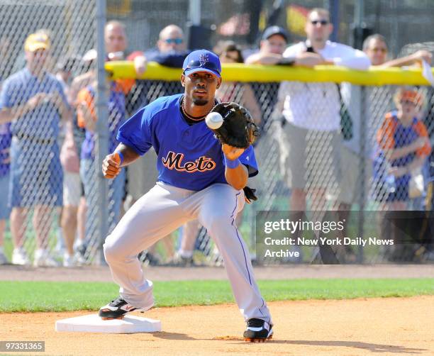 New York Mets' Jose Reyes takes a throw during morning drills at Tradition Field during the team's first full-squad workout at spring training camp.