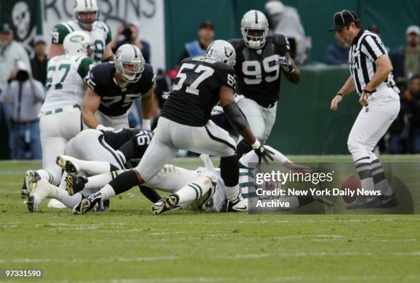 Oakland Raiders' defense converge on the loose ball as New York Jets' quarterback Chad Pennington reaches for it after giving up a fumble in the...