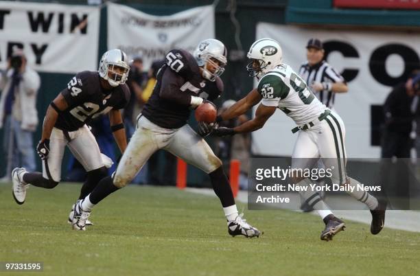 Oakland Raiders' Eric Barton intercepts a pass intended for New York Jets' Kevin Swayne in the fourth quarter of the AFC divisional playoff game at...