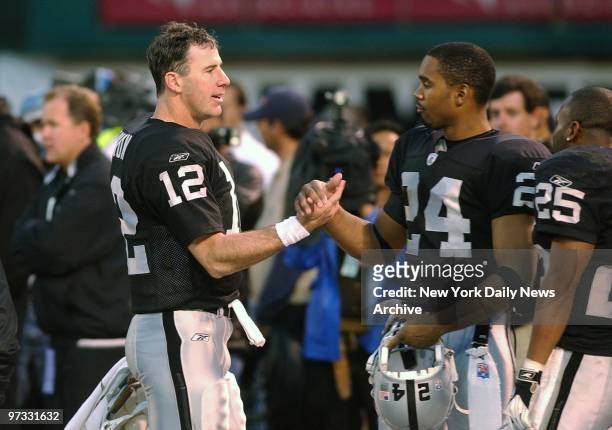 Oakland Raiders' quarterback Rich Gannon and cornerback Charles Woodson shake hands in celebration after beating the New York Jets, 30-10, in the AFC...