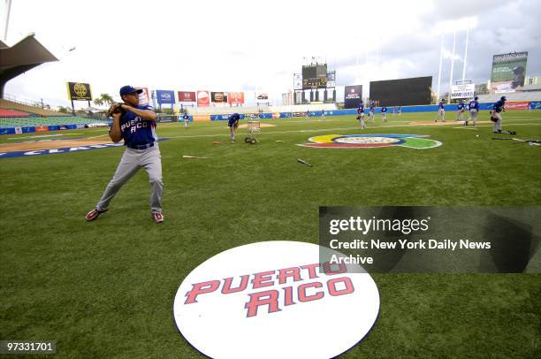 Team Puerto Rico's Carlos Beltran throws the ball around at Hiram Bithorn Stadium as he practices for the World Baseball Classic.