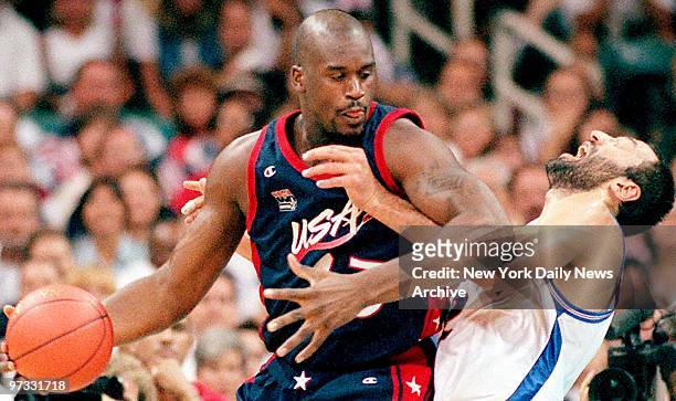Team USA basketball player Shaquille O'Neal backs up into Yugoslavia's Vlade Divac during men's Olympic final.