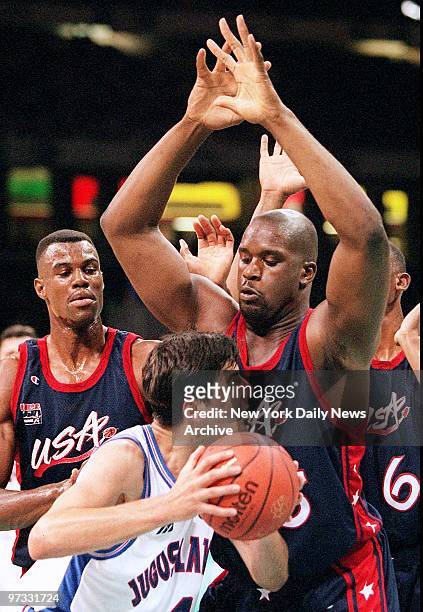 Team USA basketball player Shaquille O'Neal guards Yugoslavia's Dejan Bodiroga as David Robinson looks on during the men's final at the Summer...