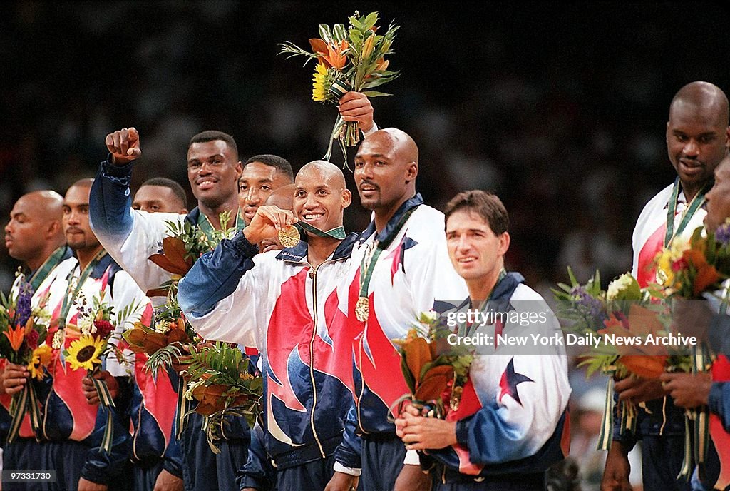 Team USA member Reggie Miller (center) flashes his gold meda