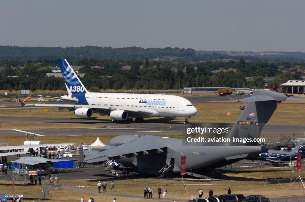 USAF Boeing C-17A Globemaster III parked in the static-display with the Airbus A380-800 taxiing behind at the 2006 Farnborough International Airshow