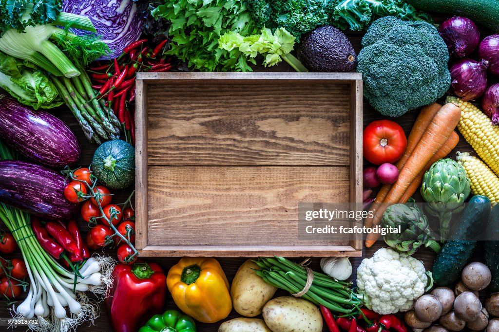 Empty wooden crate and vegetables