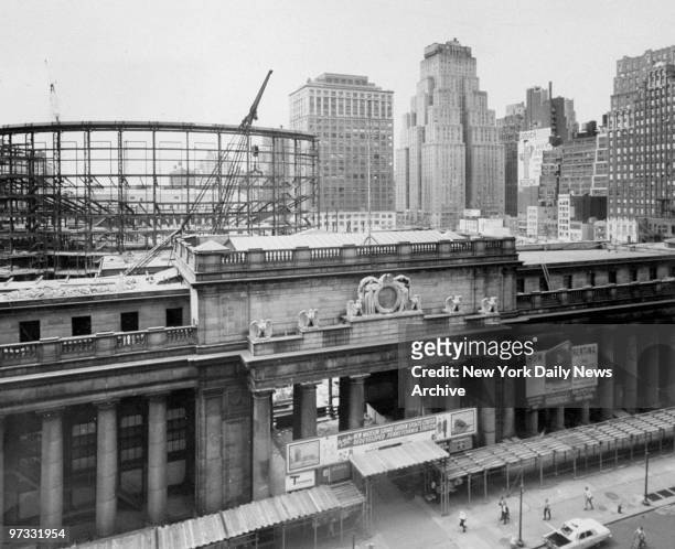 View of last remaining section of old Penn Station as workmen prepare to tear it down. The new section of Madison Square Garden can be seen in the...