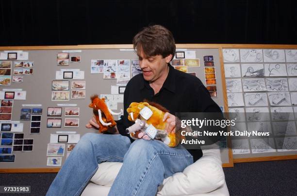 Director Chris Wedge toys with some prehistoric-looking stuffed animals at his office in White Plains. His movie "Ice Age" is soon to be released. It...