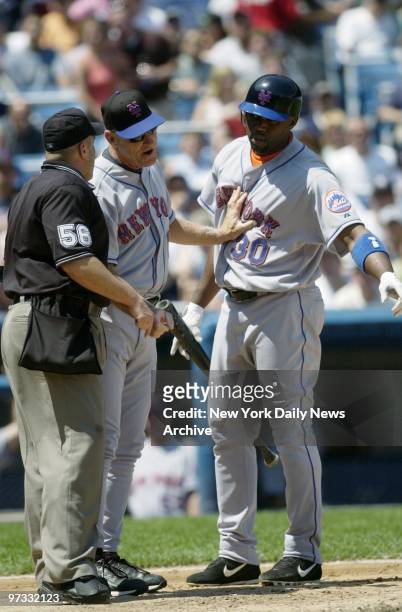 New York Mets' manager Art Howe holds back outfielder Cliff Floyd, who argues a strike call with the home plate umpire in the first game of a...