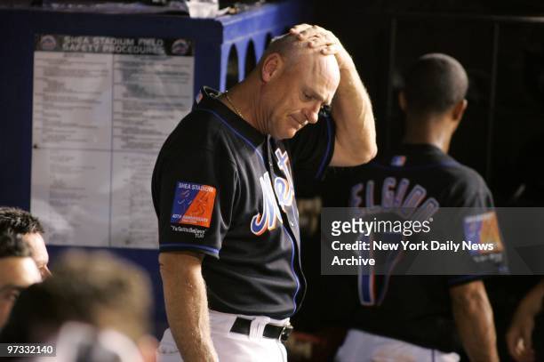 New York Mets' manager Art Howe rubs his head in search of answers as the Mets blow the lead in the seventh inning against the Florida Marlins at...