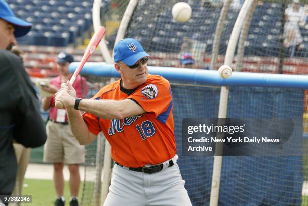 New York Mets' manager Art Howe seems to be hitting doubles - two balls at a time - during fielding practice at Vero Beach, Fla., where the Mets took...