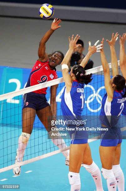 Ogonna Nnamani of the U.S. Spikes the ball over Russia's Ekaterina Gamova and Irina Tebenikhina in a preliminary vollyball match at Peace and...
