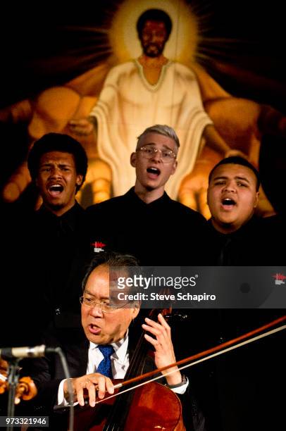 French-born American cellist Yo-Yo Ma performs, with members of the Chicago Children's Choir, at St Sabina's Church, Chicago, Illinois, June 10, 2018.